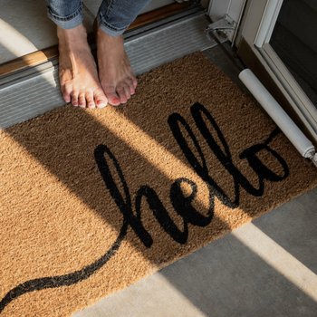 welcome mat in front of new home